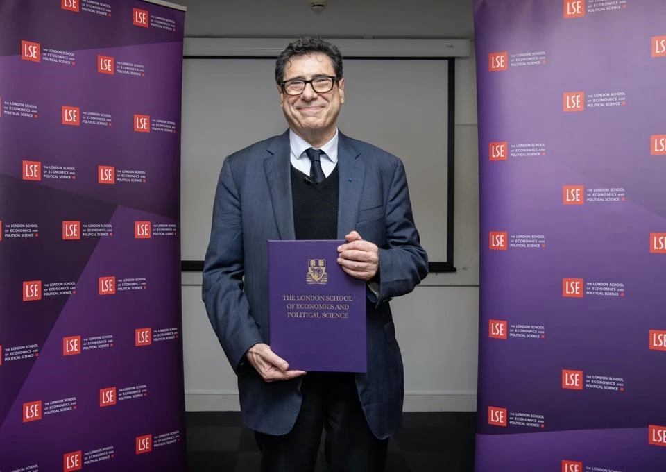 Professor Philippe Aghion, holding a gift book, given in celebration of receiving Nobel prize